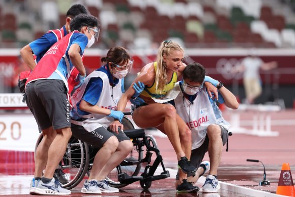 Genevieve Gregson is taken off in a wheelchair after rupturing her Achilles.