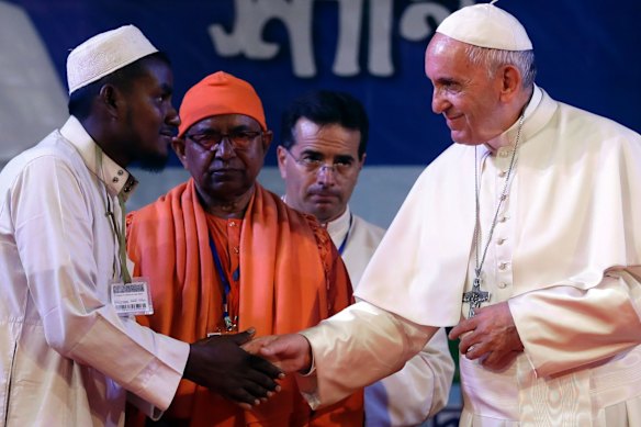 Pope Francis (right) shakes hands with a Rohingya Muslim refugee during an interfaith and ecumenical meeting for peace in Dhaka, Bangladesh in 2017. 