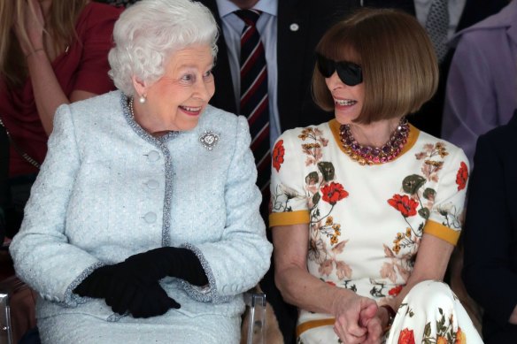 Queen Elizabeth II sits next to Vogue editor-in-chief Anna Wintour at London Fashion Week in 2018.