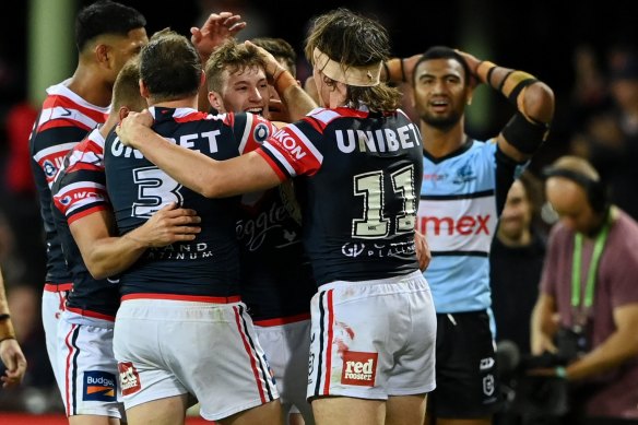 Sam Walker (centre) celebrates with Roosters teammates on Saturday night.