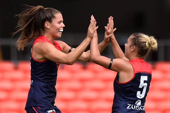 Kate Hore (left) celebrates her goal with Demons teammate Tyla Hanks.