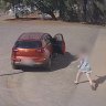 A woman rushes to her car after it is allegedly stolen by a 15-year-old boy in Kalgoorlie while her son is inside.