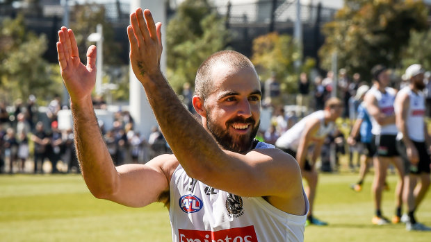 Steele Sidebottom applauds the Magpie fans at training on Thursday.