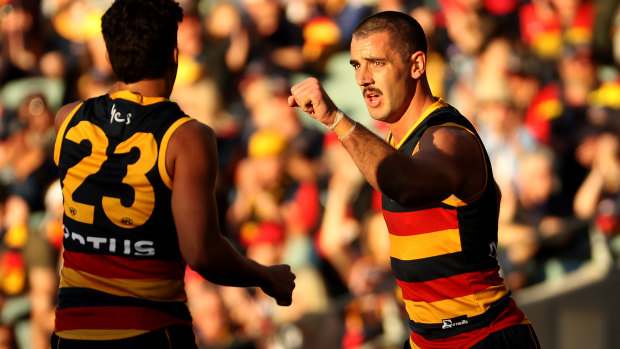 Taylor Walker (right) celebrates a goal.