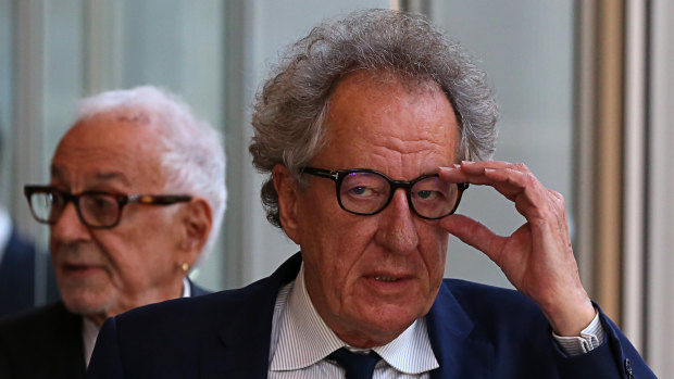 Geoffrey Rush arrives at court on Thursday flanked by Fred Specktor.