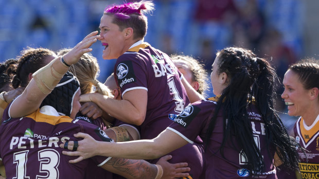 Too strong: The Broncos celebrate at full-time after sealing the NRLW title.