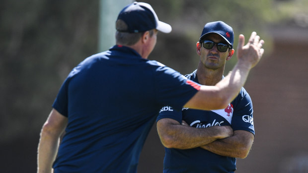 Brains trust: Andrew Johns with Trent Robinson during a Roosters training session in March. 