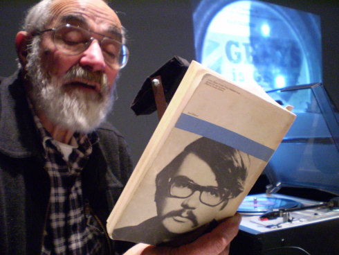 Actor John Flaus reads a book showing an early picture of Jack Hibberd.