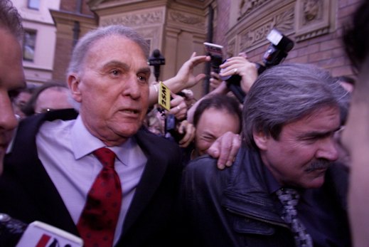 Shielded by bodyguards and court sheriffs, Laws leaves the Supreme Court after receiving a 15-month suspended sentence for contempt of court.