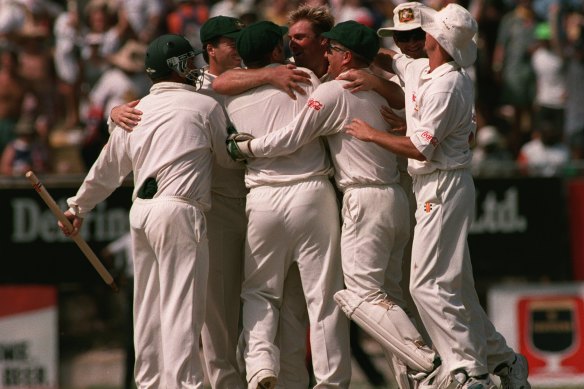 Teammates mob Shane Warne after the final wicket falls in Kingston to seal Australia’s famous series win in 1995.