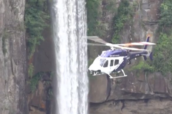 Police and SES crews search Morton National Park where a woman is missing.