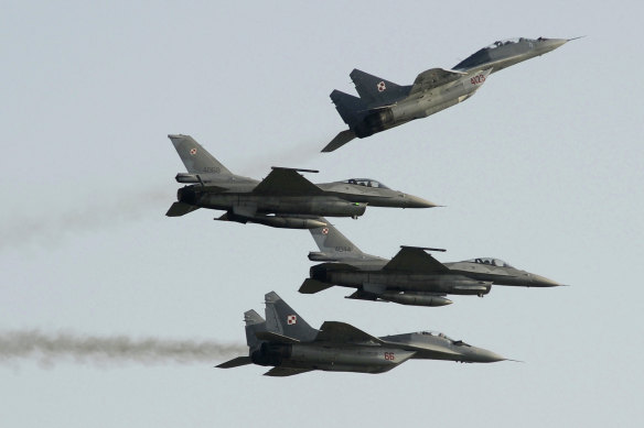 Two Polish Air Force MiG-29 jets fly above and below two Polish Air Force F-16 jets at an airshow in 2011. The Pentagon says flying Polish warplanes from US bases to help Ukraine is “untenable”. 