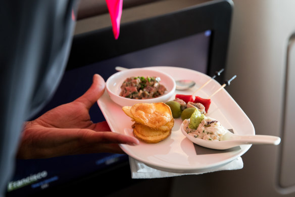 Qantas business class passengers on international flights still get fancy meals (above) but don’t expect similar on a domestic flight.