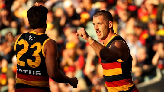 Taylor Walker (right) celebrates a goal.