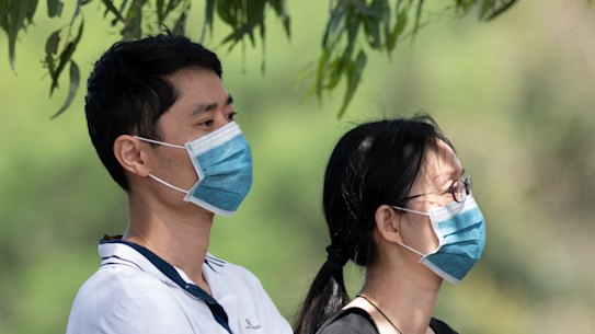 Parents wait outside Epping Boys High School to collect their sons returning from Year 9 camp. 