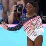 Simone Biles of Team United States reacts after finishing her routine in the floor exercise while teammates Jade Carey, Jordan Chiles, Hezly Rivera and Sunisa Lee cheer.