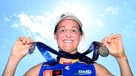 Brisbane captain Breanna Koenen proudly displays the two medals she collected at the 2023 AFLW grand final.