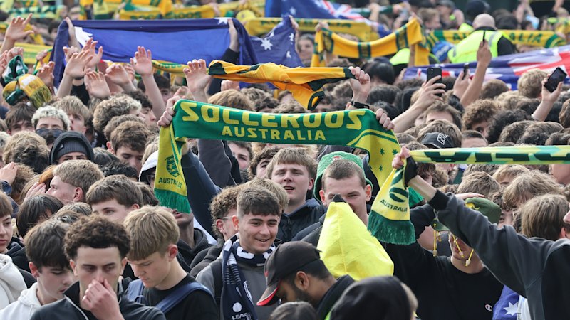 Flares, a fight and a capacity crowd as rowdy Socceroos fans pack Federation Square