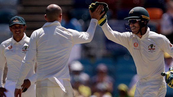 Easy prey: Nathan Lyon is congratulated by Time Paine after taking the wicket of Chamika Karunaratne.