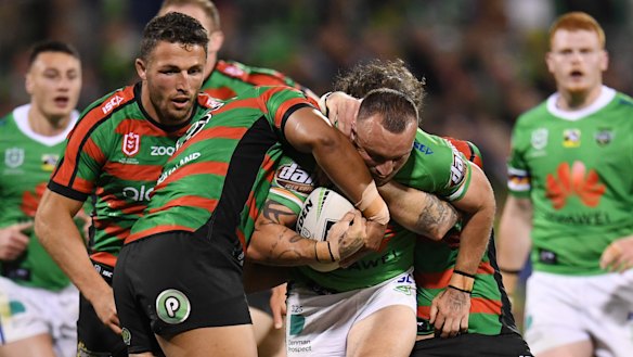 On a mission: Josh Hodgson tries to break the Rabbitohs defensive line last night.