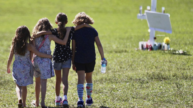 Children console each other after the shooting at Marjory Stoneman Douglas High.