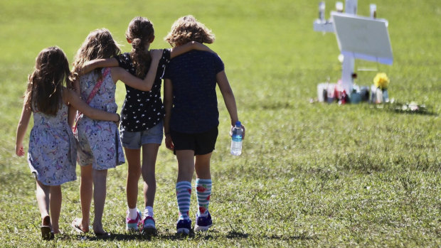 Children console each other after the shooting at Marjory Stoneman Douglas High.
