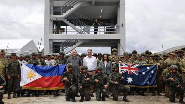 Australian Defence Minister Richard Marles, centre, with Philippine National Defence Secretary Gilberto Teodoro jnr, centre left, Australian ambassador to the Philippines Hae Kyong Yu, centre right, and Australian and Filipino forces before the drills.