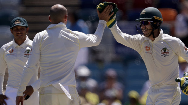 Easy prey: Nathan Lyon is congratulated by Time Paine after taking the wicket of Chamika Karunaratne.