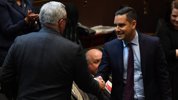 State Member for Sydney Alex Greenwich shakes hands with Minister for Health and Medical Research Brad Hazzard after introducing the Reproductive Healthcare Reform Bill.
