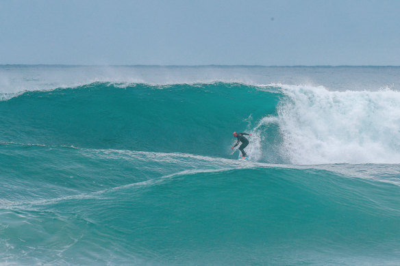 Formston heads down the front of a wave more than twice his size.