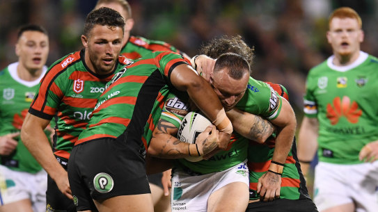 On a mission: Josh Hodgson tries to break the Rabbitohs defensive line last night.