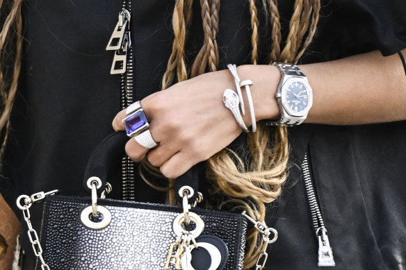 Right on time: A guest outside the Dior show in Paris brandishing her luxury watch in a sea of accessories.