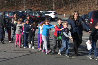 Children leave Sandy Hook school after the shooting.