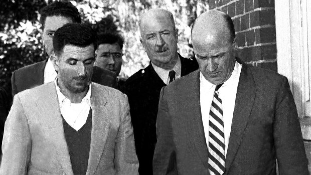 David Scanlon AKA the Kingsgrove Slasher, pictured on 1 May, 1959 at Kogarah with police following his capture.