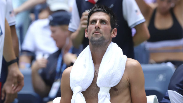 Novak Djokovic tries to deal with the heat at the US Open.