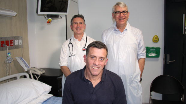 Cystic Fibrosis patient Darren Bullock (centre) with Dr David Reid (left) and Professor Scott Bell (right).