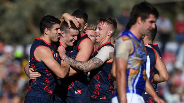 Leading light: Dees come together to congratulate Bayley Fritsch (2nd left) after a major score.