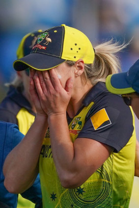 Ellyse Perry reacts as she leaves field.