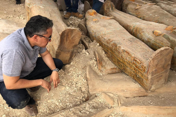 The Egyptian Minister of Antiquities Khaled el-Anany looking at recently discovered ancient coloured coffins with inscriptions and paintings, in the southern city of Luxor, Egypt. 