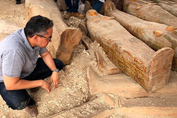 The Egyptian Minister of Antiquities Khaled el-Anany looking at recently discovered ancient coloured coffins with inscriptions and paintings, in the southern city of Luxor, Egypt. 