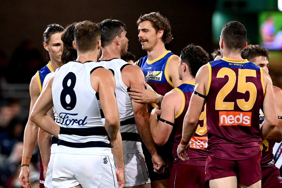 Joe Daniher, who has been fined for staging against the Cats on Thursday night, and Geelong’s Tom Hawkins.