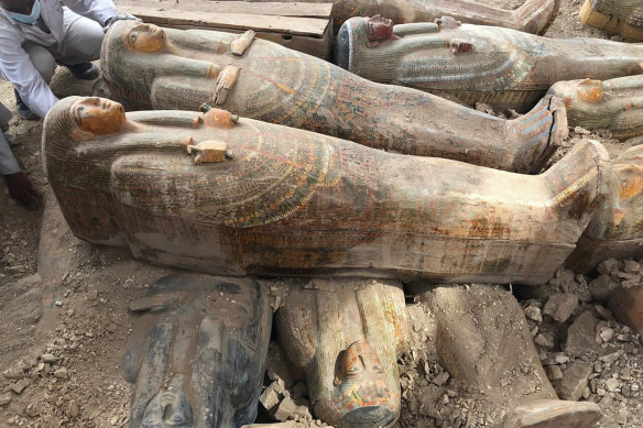 This photo provided by the Egyptian Ministry of Antiquities shows recently discovered ancient coloured coffins with inscriptions and paintings, in the southern city of Luxor, Egypt. 