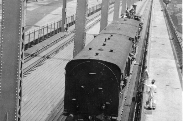 The first train crosses the Sydney Harbour Bridge as part of testing on January 19, 1932, two months before the famed coathanger opened to the public.