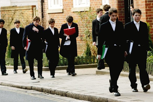 Pupils at Eton College wearing the school uniform of tailcoats and starched collars.