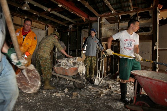 Volunteers cleaning out a home along Donatello Street in Fig Tree Pocket after the flood in 2011. 