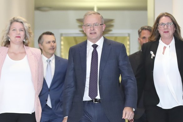 Flanked by Clare O’Neil and Catherine King (front), Mr Albanese prepares to deliver his budget response.