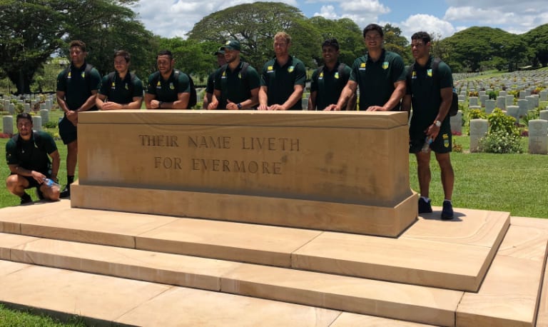 Reflective moment: Players pay their respects at Bomana War Cemetery.