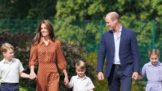 Prince George, Princess Charlotte and Prince Louis (C), accompanied by their parents the William and Catherine, Duchess of Cambridge, arrive for a settling in afternoon at Lambrook School last week. 