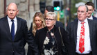 Former minister Linda Reynolds arrives at the Supreme Court in Perth for the defamation trial, with husband Robert Reid, left, and lawyer Martin Bennett.