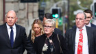 Former Minister Linda Reynolds arrives at the Supreme Court in Perth for the defamation trial, with husband Robert Reid (left) and lawyer Martin Bennett (right).